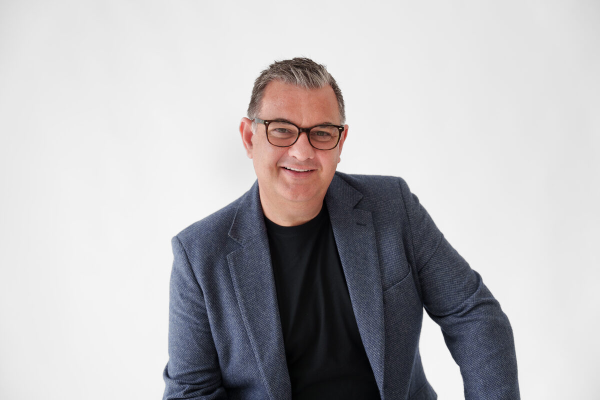 Mark Kilroy headshot — Casual professional — navy jacket, dark t-shirt
